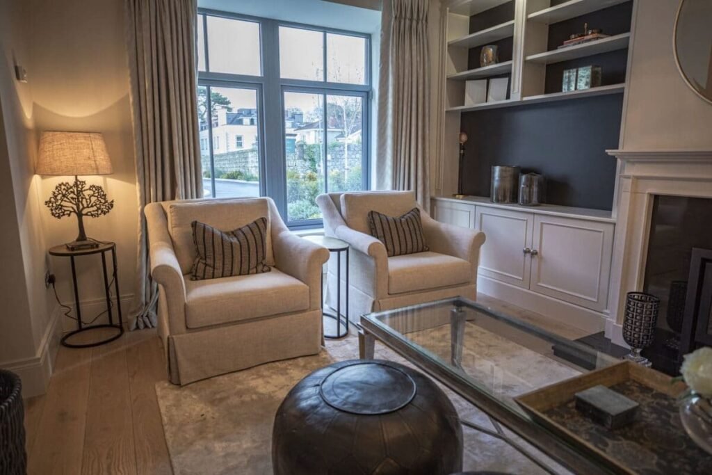 A modern living room with two grey seats.