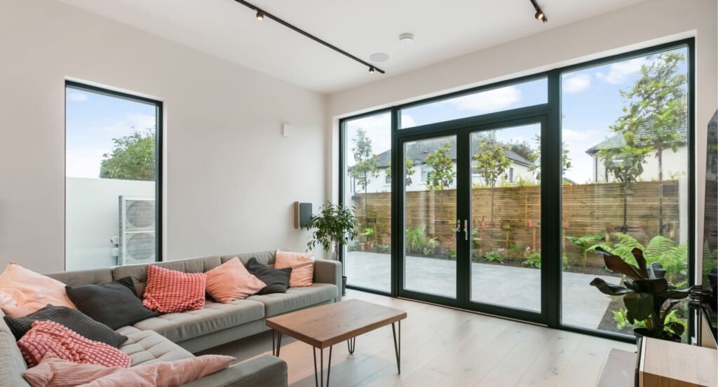 A modern living area with grey sofa.