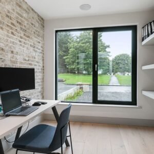 A office room with a beige brick window.