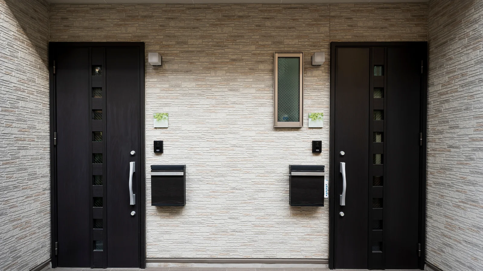 Two dark doors with small cubic windows.