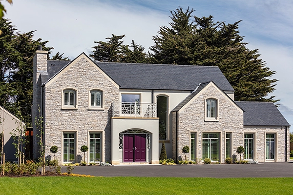 Outside view of a modern house with magenta doors.