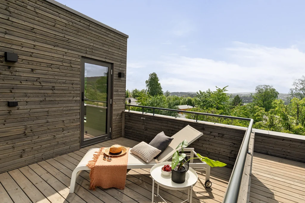 Modern wooden balcony with a laying seat.