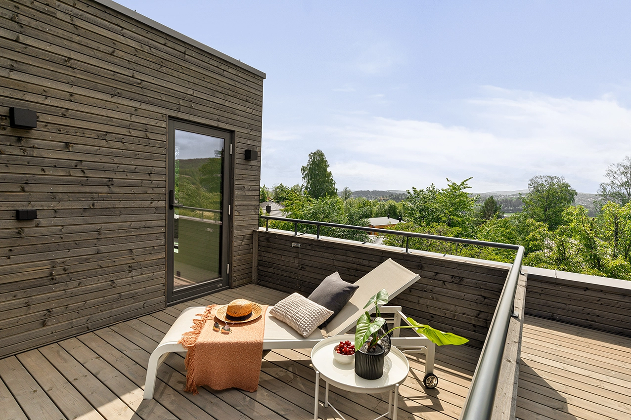 Modern wooden balcony with a laying seat.