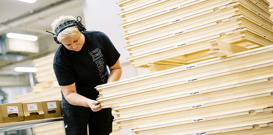 A woman stacking pallets.