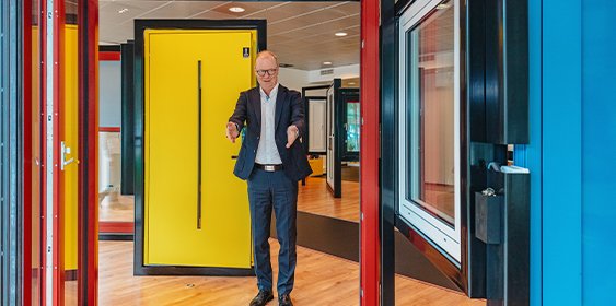 A man showing his variety of doors.