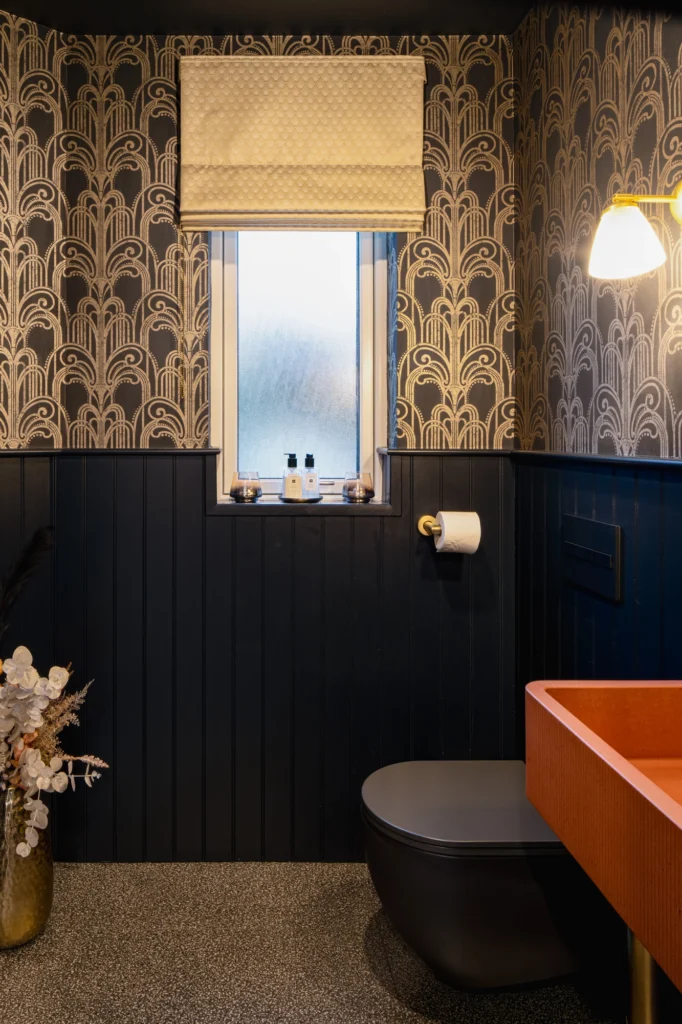 A dark blue bathroom with a texture wall design.